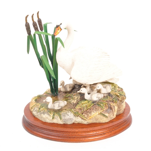 325 - Border Fine Arts - Two 20th Century Border Fine Arts figures in the form of swans both raised on cir... 