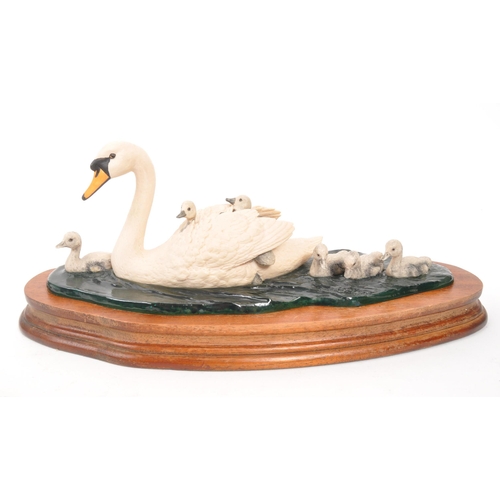 325 - Border Fine Arts - Two 20th Century Border Fine Arts figures in the form of swans both raised on cir... 