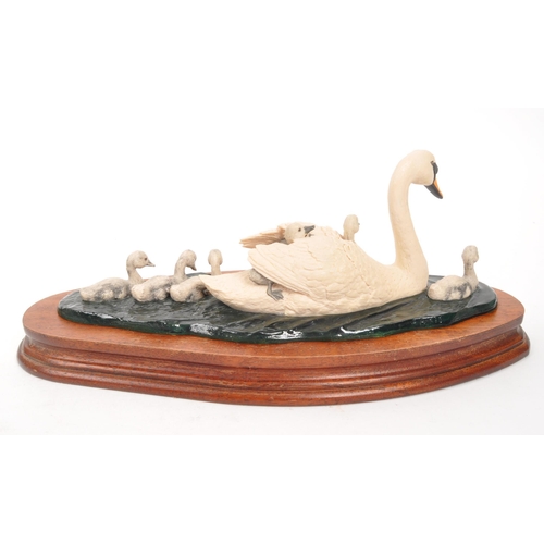 325 - Border Fine Arts - Two 20th Century Border Fine Arts figures in the form of swans both raised on cir... 