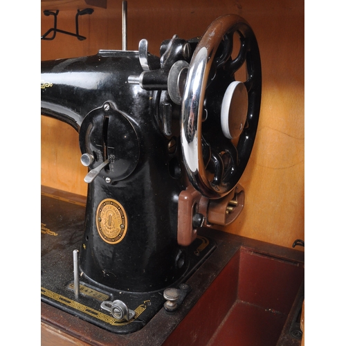 331 - Singer - A mid 20th century 1953 Singer 201k sewing machine. The sewing machine in a black colourway... 