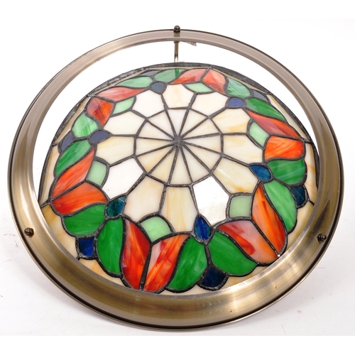 333 - A vintage Tiffany style brass and leaded stained glass ceiling light shade. White ground with red an... 