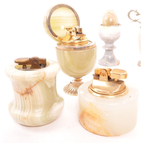 336 - A collection of vintage 20th century onyx items. To include, tabletop lighters, eggs, vases, cups, m... 