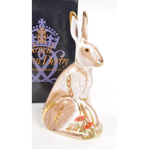 35 - Royal Crown Derby - A porcelain china Royal Crown Derby ' Midsummer Hare ' paperweight figurine. Wit... 