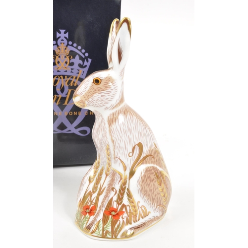 35 - Royal Crown Derby - A porcelain china Royal Crown Derby ' Midsummer Hare ' paperweight figurine. Wit... 