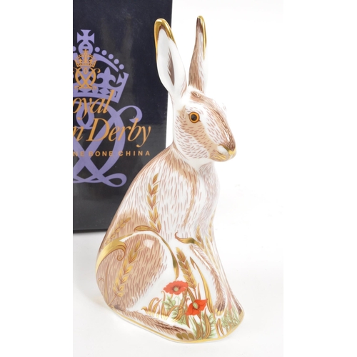 35 - Royal Crown Derby - A porcelain china Royal Crown Derby ' Midsummer Hare ' paperweight figurine. Wit... 