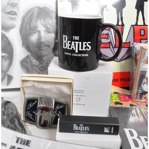 352 - The Beatles - a collection of assorted Beatles music memorabilia to include CDs, mugs, bags, tshirt,... 