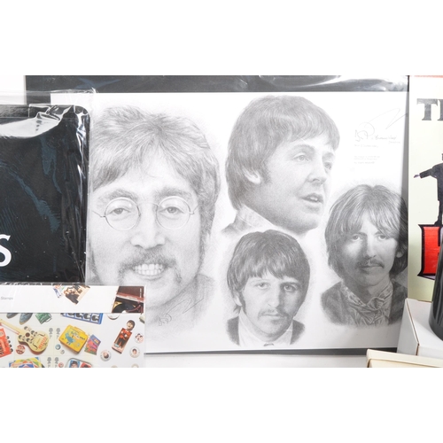 352 - The Beatles - a collection of assorted Beatles music memorabilia to include CDs, mugs, bags, tshirt,... 