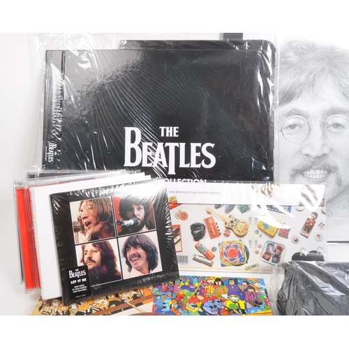 352 - The Beatles - a collection of assorted Beatles music memorabilia to include CDs, mugs, bags, tshirt,... 