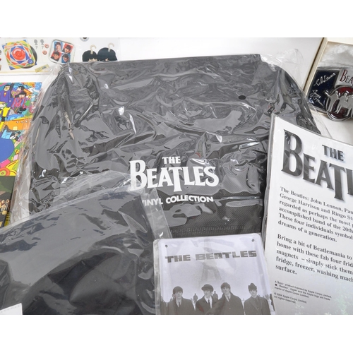 352 - The Beatles - a collection of assorted Beatles music memorabilia to include CDs, mugs, bags, tshirt,... 