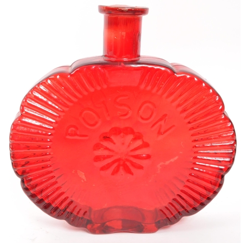 361 - A vintage red glass bottle having a central moulded floral motif with ' Poison ' lettering surrounde... 