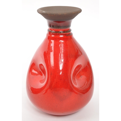 361 - A vintage red glass bottle having a central moulded floral motif with ' Poison ' lettering surrounde... 