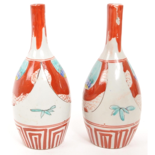 364 - A pair of vintage Japanese sake bottle / vases with an Imari palette dipicting bamboo and blossom mo... 