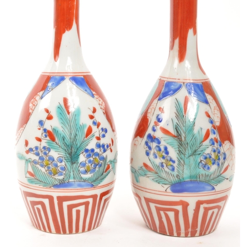 364 - A pair of vintage Japanese sake bottle / vases with an Imari palette dipicting bamboo and blossom mo... 