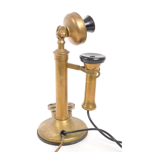 369 - A vintage brass and Bakelite candlestick telephone with rotary dial and hook with ear piece. Measure... 