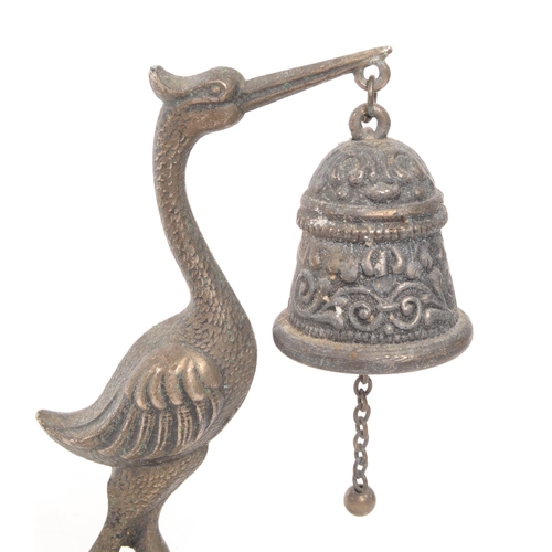 372 - A small vintage table bell of metal construction moulded into the shape of a long legged Heron bird ... 