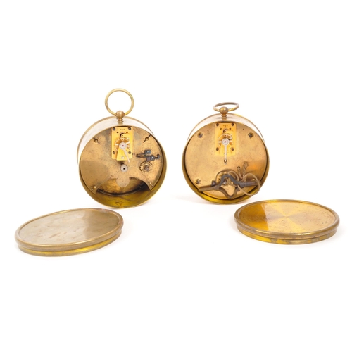 378 - Two early 20th Century brass campaign / travel drum alarm clocks. White clock faces with Roman numer... 