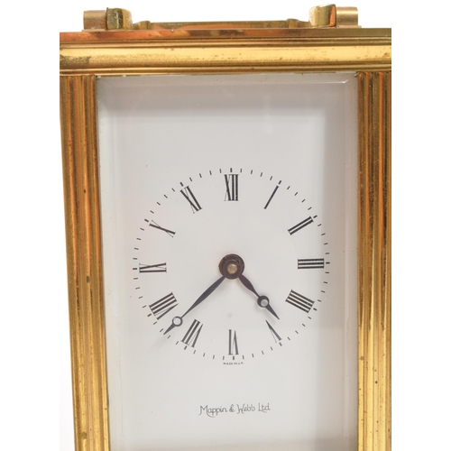 380 - An original Mappin & Webb brass cased carriage mantel clock set within bevelled glass panel side... 