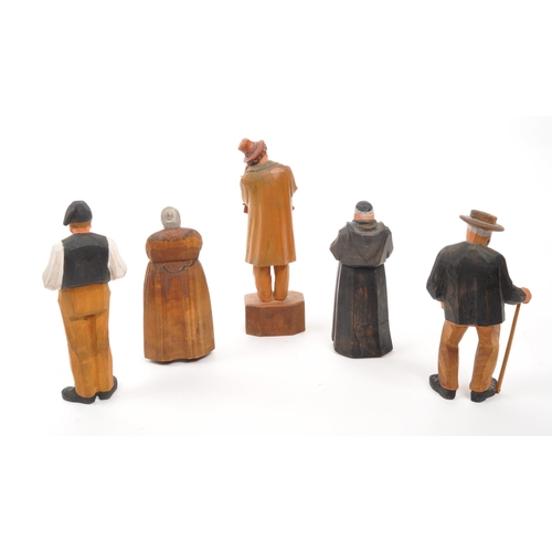 386 - A collection of five 20th century Swiss carved painted folk figures. The figures comprising of a fou... 