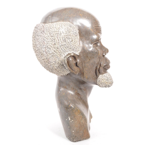 391 - A 20th century carved African Tribal soapstone bust. The bust in the form of a man. 