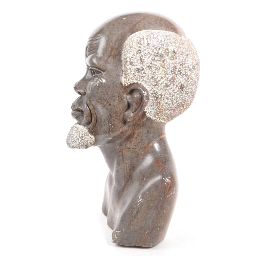 391 - A 20th century carved African Tribal soapstone bust. The bust in the form of a man. 