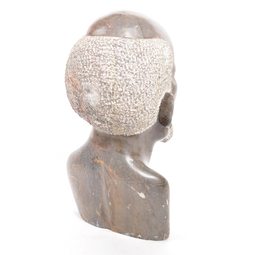 391 - A 20th century carved African Tribal soapstone bust. The bust in the form of a man. 