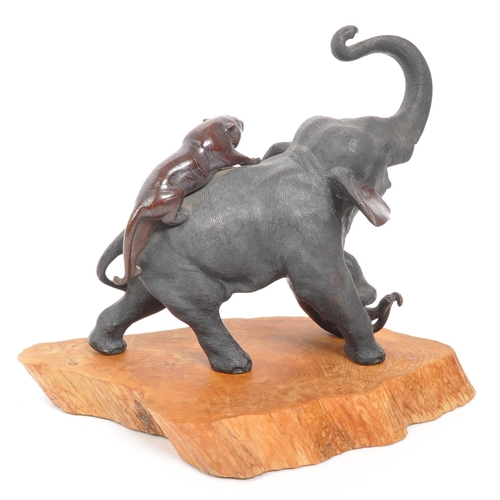 393 - A Meiji Period late 19th century bronze sculpture figure of an elephant fighting off tigers. AF. Wit... 