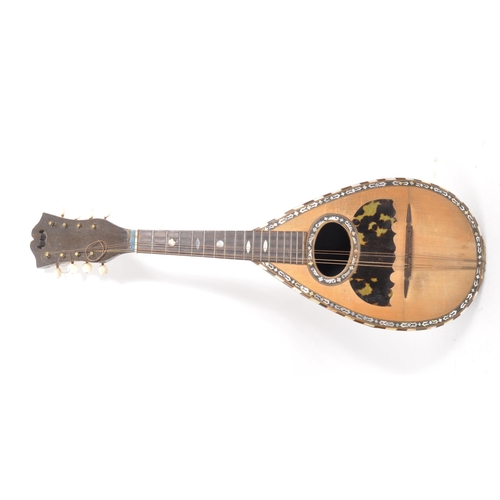 411 - A 19th Century bowl back mandolin musical instrument, with tortoiseshell scratch plate and mother of... 