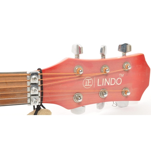 420 - Lindo - A contemporary Lindo acoustic guitar. The guitar having a red body, with black scratch plate... 