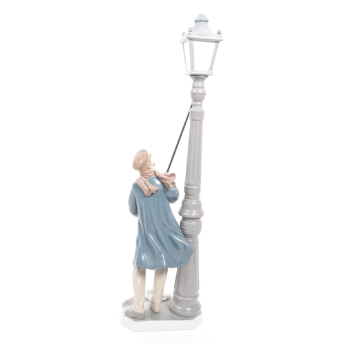 423 - Lladro - A vinatge 20th century Spanish porcelain Lladro lamp lighter figurine. The figurine being m... 