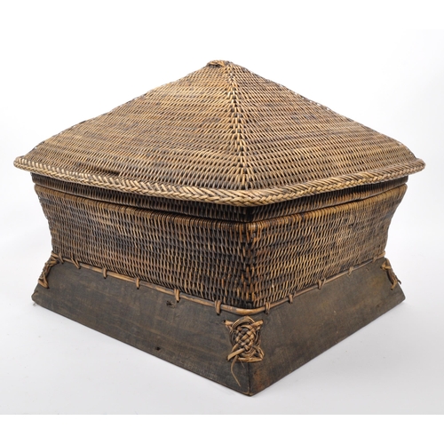 434 - A large Chinese bamboo wicker storage basket in Pagoda shape set on a wooden base with plaited detai... 