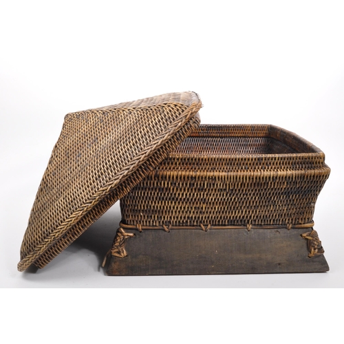 434 - A large Chinese bamboo wicker storage basket in Pagoda shape set on a wooden base with plaited detai... 