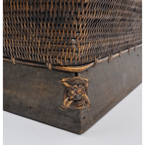 434 - A large Chinese bamboo wicker storage basket in Pagoda shape set on a wooden base with plaited detai... 