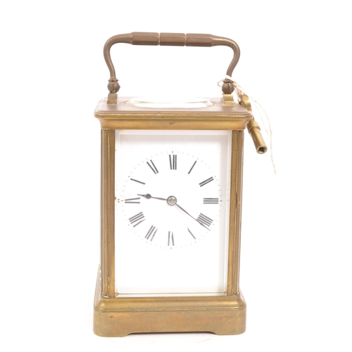 436 - An early 20th century brass carriage mantel clock. Movement to verso, white face with ebonised chapt... 