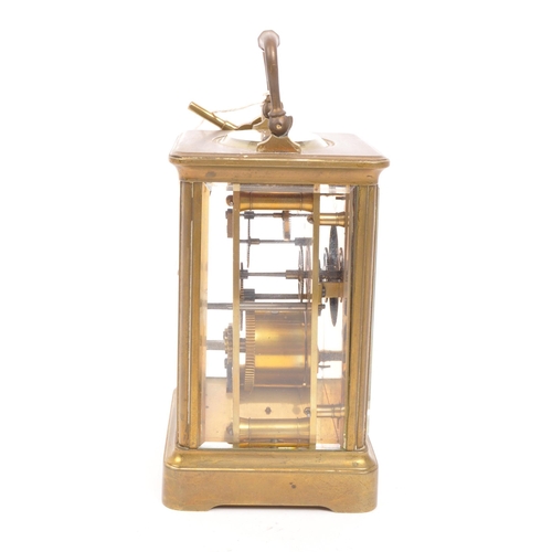 436 - An early 20th century brass carriage mantel clock. Movement to verso, white face with ebonised chapt... 