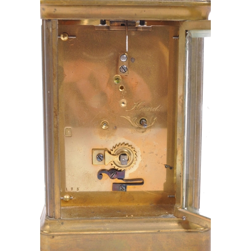 436 - An early 20th century brass carriage mantel clock. Movement to verso, white face with ebonised chapt... 