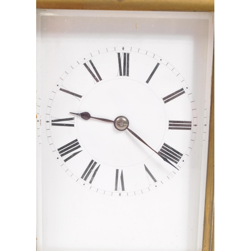 436 - An early 20th century brass carriage mantel clock. Movement to verso, white face with ebonised chapt... 