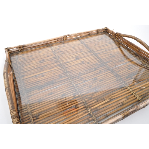 439 - A large bamboo butlers tray / serving tray with glass top, two carry handles and rattan weaves and p... 