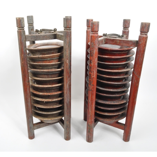 440 - A pair of wooden Chinese plate stacking caddy racks operated by releasing one of the wooden legs to ... 