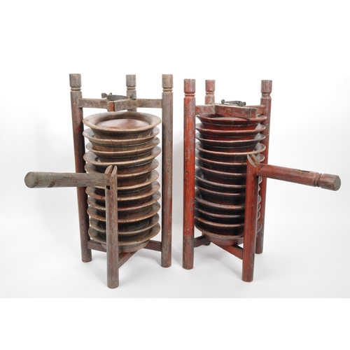 440 - A pair of wooden Chinese plate stacking caddy racks operated by releasing one of the wooden legs to ... 