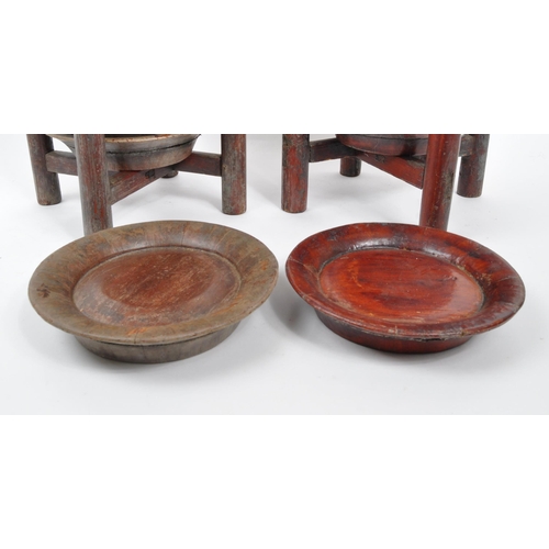 440 - A pair of wooden Chinese plate stacking caddy racks operated by releasing one of the wooden legs to ... 