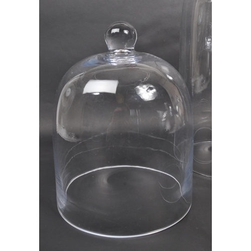 441 - A collection of four glass dome case. Of dome form with three examples having ball finials to top. N... 