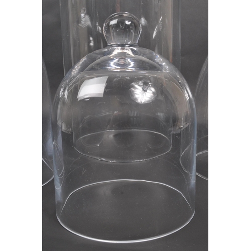 441 - A collection of four glass dome case. Of dome form with three examples having ball finials to top. N... 