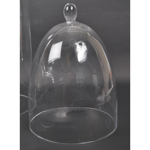 441 - A collection of four glass dome case. Of dome form with three examples having ball finials to top. N... 