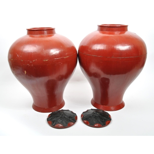 442 - Pair of red lacquered Chinese Asian lidded vase / urns / planters. Bulbous form, wooden construction... 