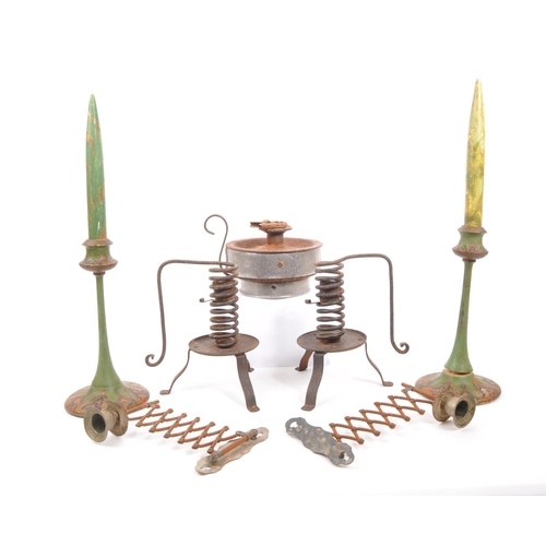 449 - A collection of industrial metal work candle sticks / lamps. To include a pair of wooden spring cand... 