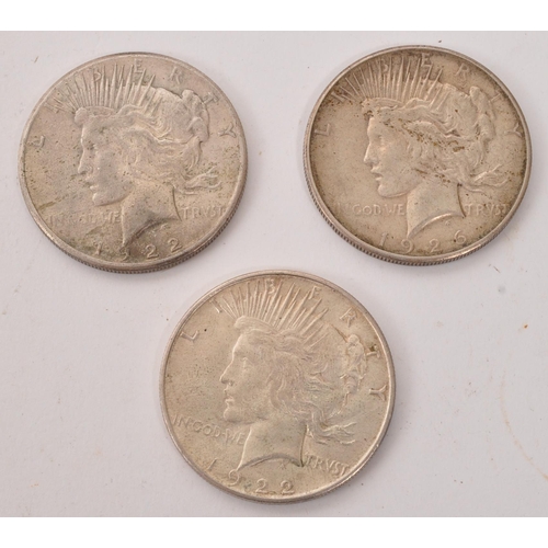 513 - Two 1922 USA ' Peace ' Dollar coins, alongside another 1926 example. Each of the dollars being of .9... 