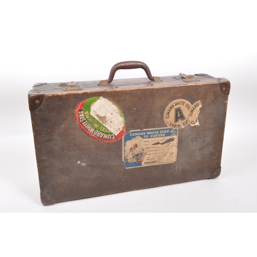 545 - A 20th century circa 1930s suitcase with Cunard White Star A Class cabin and other stickers to outsi... 