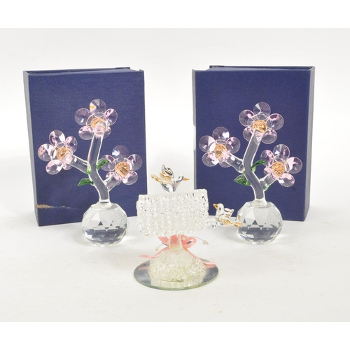 83 - A pair of crystal glass flower figures by Balmoral Crystal. Each having circular glass base with thr... 