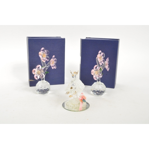 83 - A pair of crystal glass flower figures by Balmoral Crystal. Each having circular glass base with thr... 