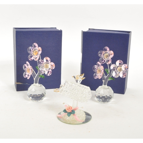 83 - A pair of crystal glass flower figures by Balmoral Crystal. Each having circular glass base with thr... 